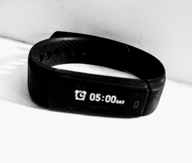 This photo is intended to demonstrate that the discussion in this blog post relates to setting an intention to wake up early in the morning.The black and white image shows a smart wrist watch with the alarm symbol on the screen and the time of the alarm set to the early morning hour of 5am. The alarm is set ready to help the owner the watch wake up earlier.