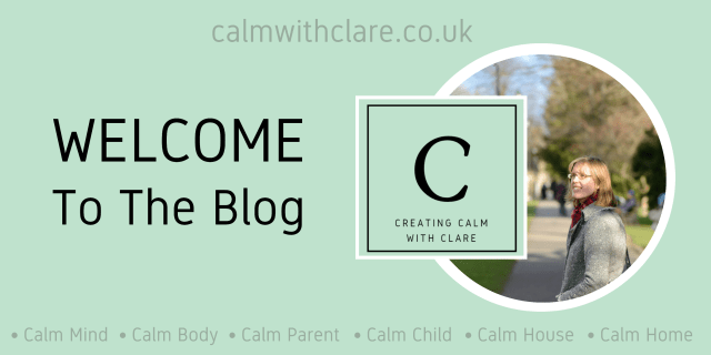 An image to Welcome readers to the blog, Creating Calm with Clare. It includes a photograph of the author, Clare. She is wearing glasses, has long hair and is wearing a grey coat with a red scarf. She is standing in a park with trees. The image also includes the blog's square, green logo; the web address and; the blog’s category headings are listed as calm mind, calm body, calm parent, calm child, calm house, calm home.
